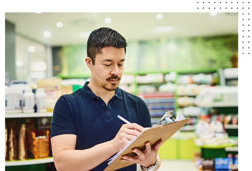 Man with clipboard in grocery store