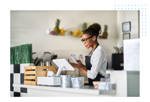 Woman at cash register inputting information onto a tablet